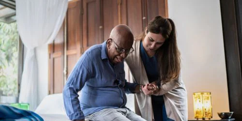 home healthcare specialist assisting older man
