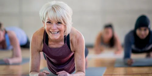 older woman doing plank strength training exercise