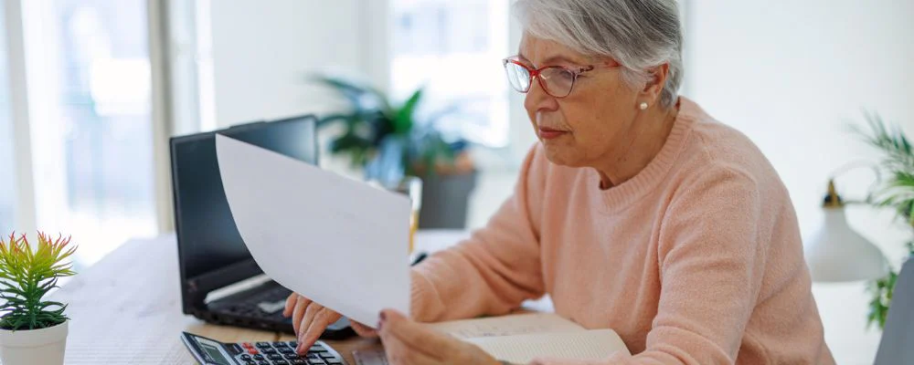 Older woman calculating Medicare out-of-pocket costs
