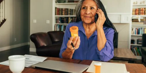 Older woman calling about prescription drug plan options