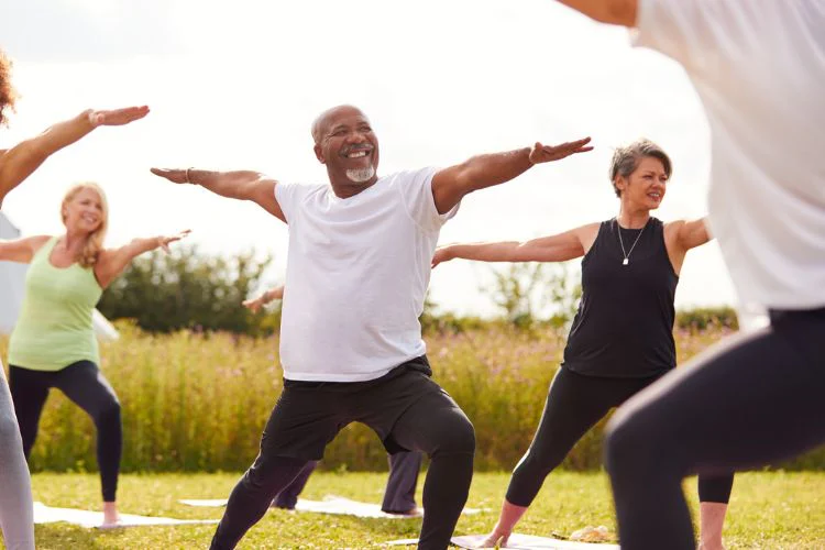 Group of older adults doing yoga outside