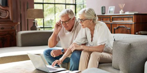 Older couple comparing Medicare options on computer