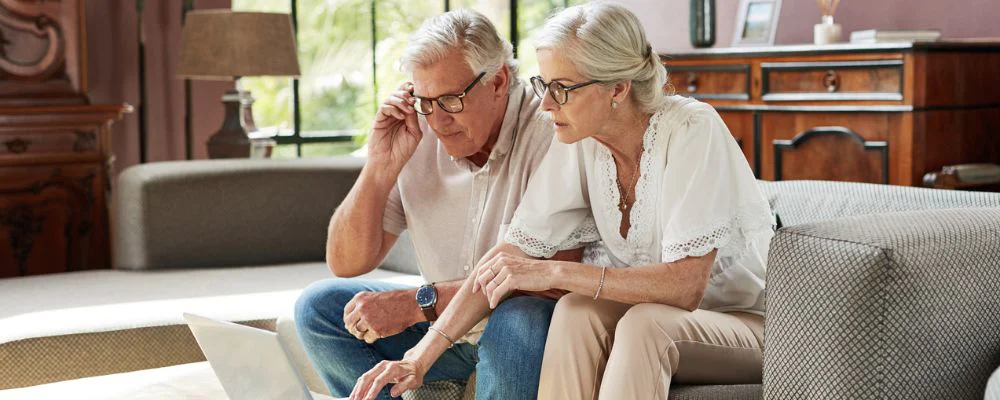 Older couple comparing Medicare options on computer