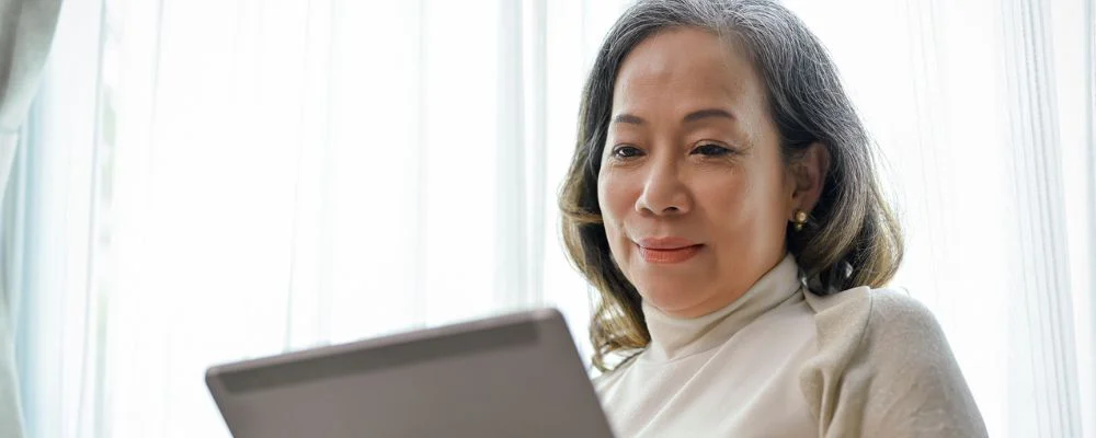 older woman using a tablet hero