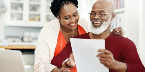 two older adults looking at HSA savings for Medicare expenses