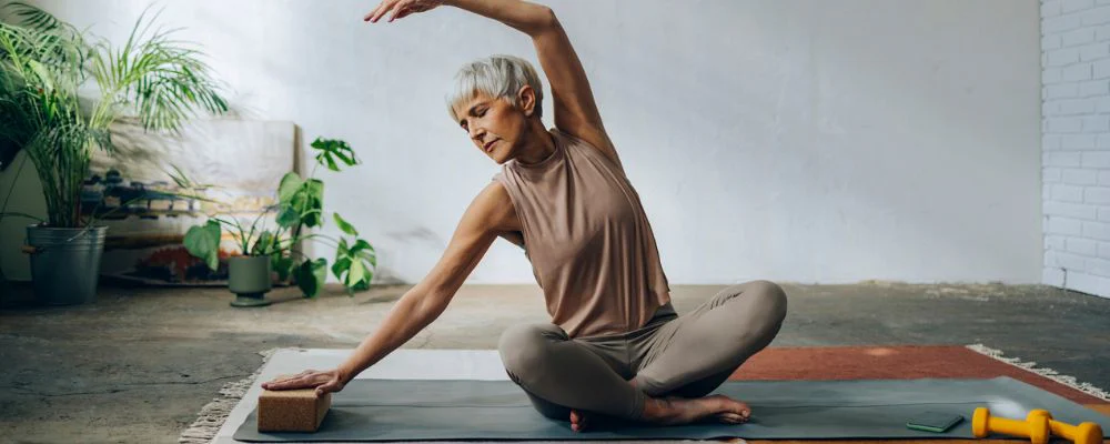 Woman stretching on yoga mat
