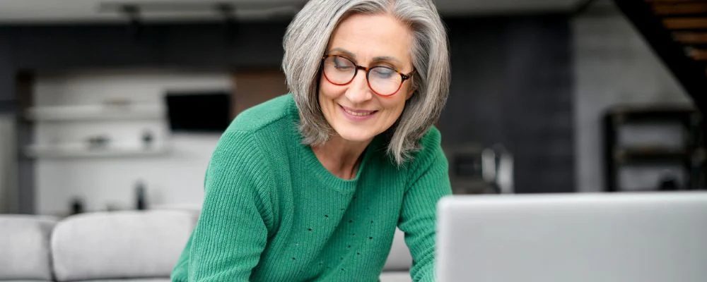 older woman calculating medicare irmaa surcharge