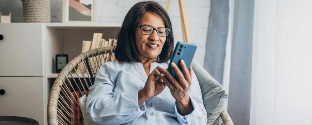 older woman researching Medicare eligibility on phone