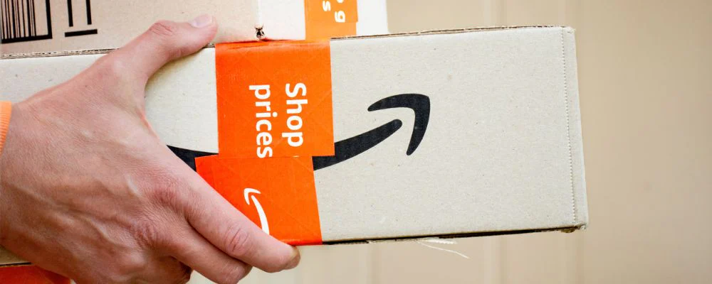 Person holding Amazon boxes