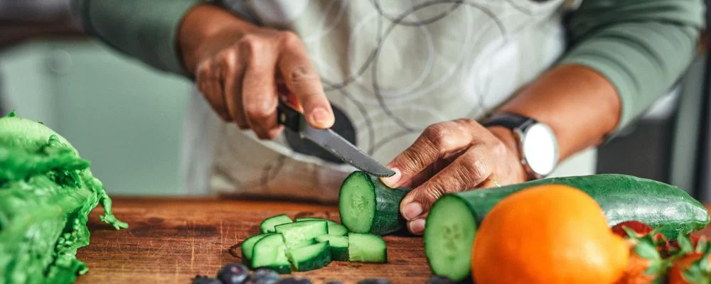 Person cutting fruits and vegetables