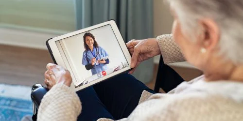 Woman using telehealth services with Medicare