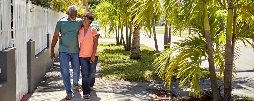 Couple walking through palm trees in Florida