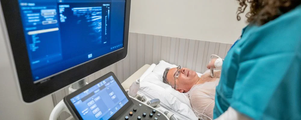 Man and healthcare provider taking echocardiogram