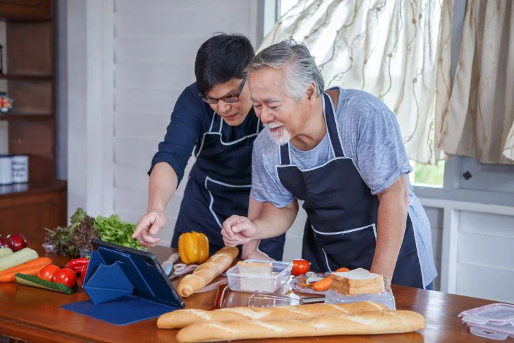 Father and son participating in cooking class online