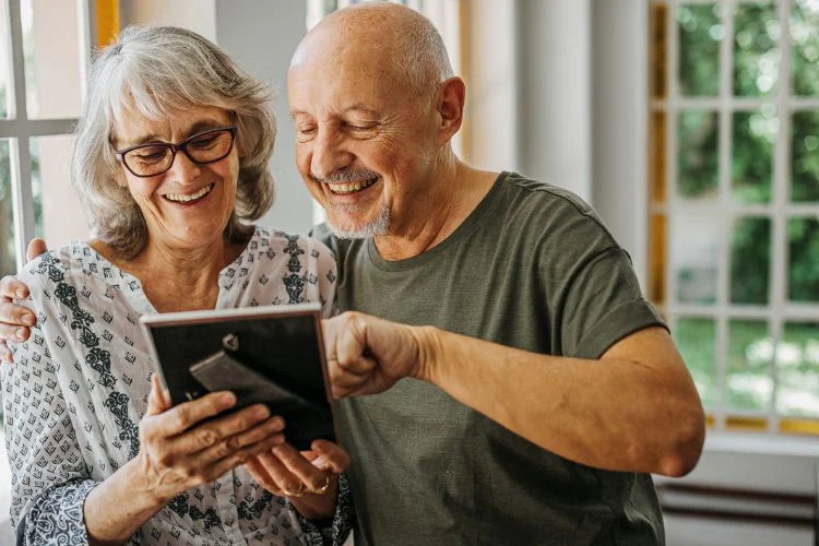 Older couple looking at photo frame