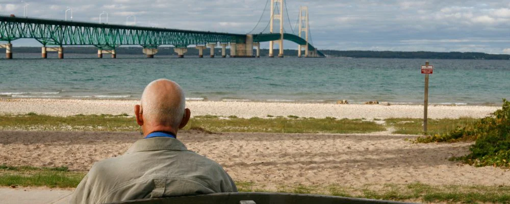 Older man looking at bridge in Michigan