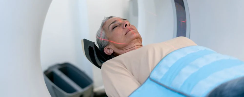 Woman lying down for CT scan