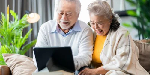 Senior couple looking at info on tablet