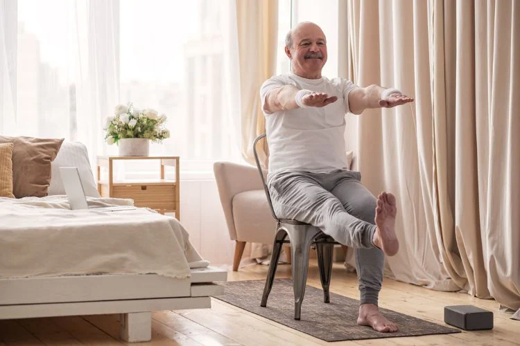 Man doing chair exercises in bedroom
