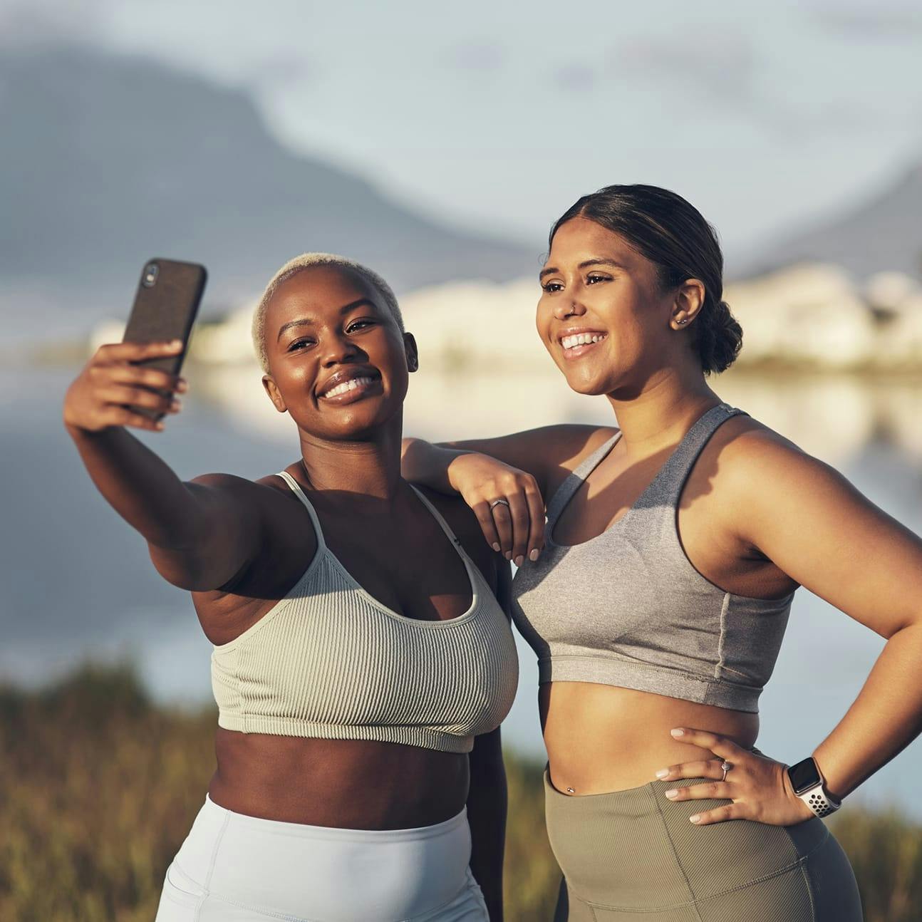 two women taking a selfie during an outdoor workout