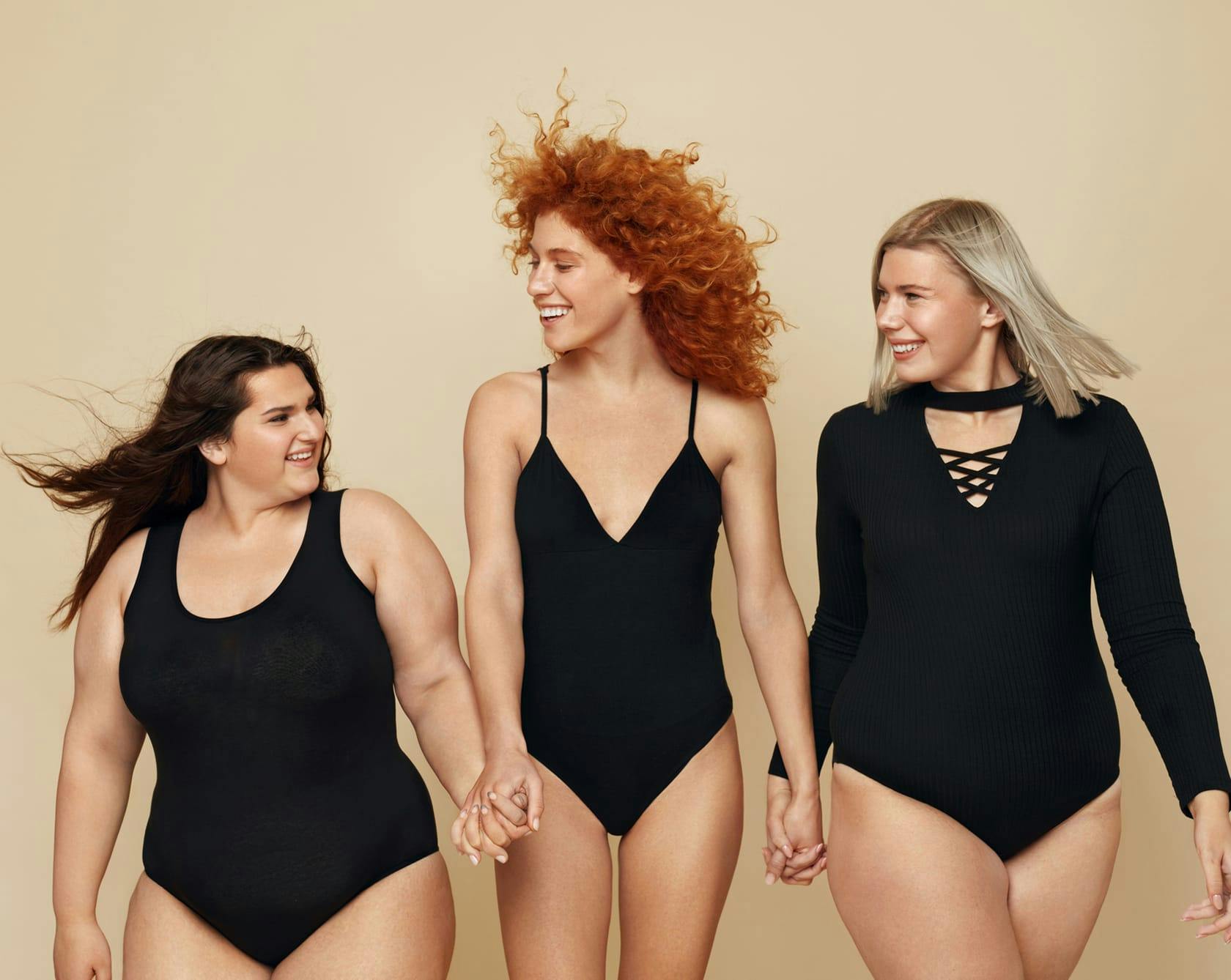 3 woman wearing black bodysuits