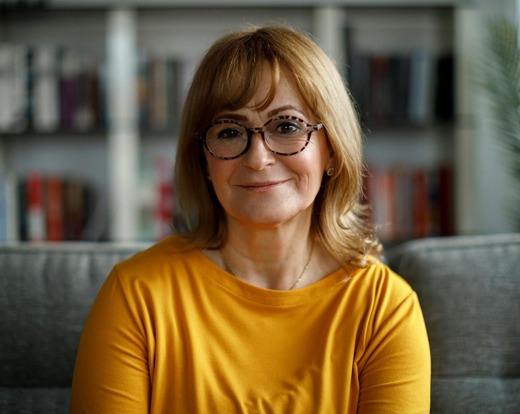 Woman in a yellow top and glasses