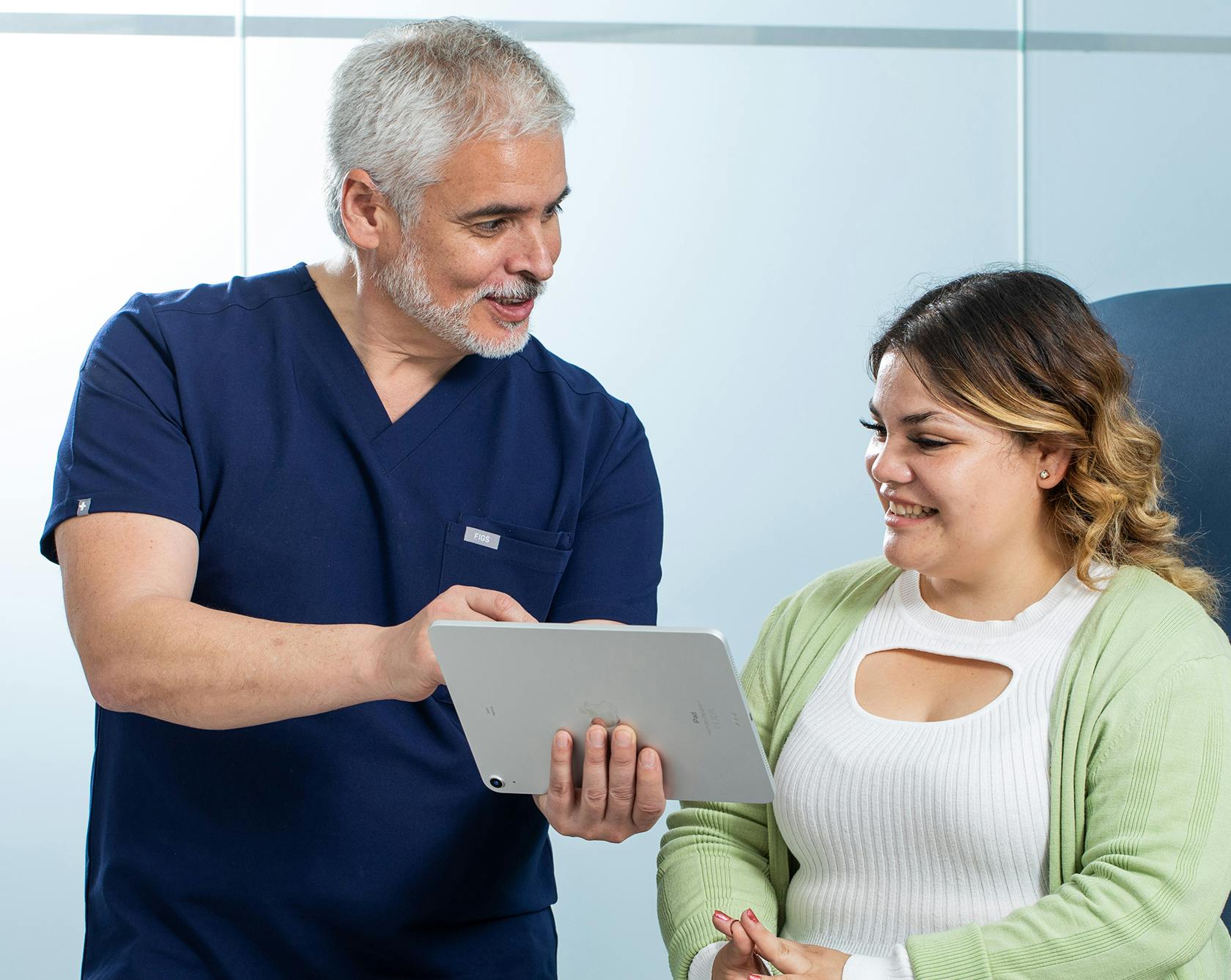 Doctor Showing Patient Something on a Clipboard