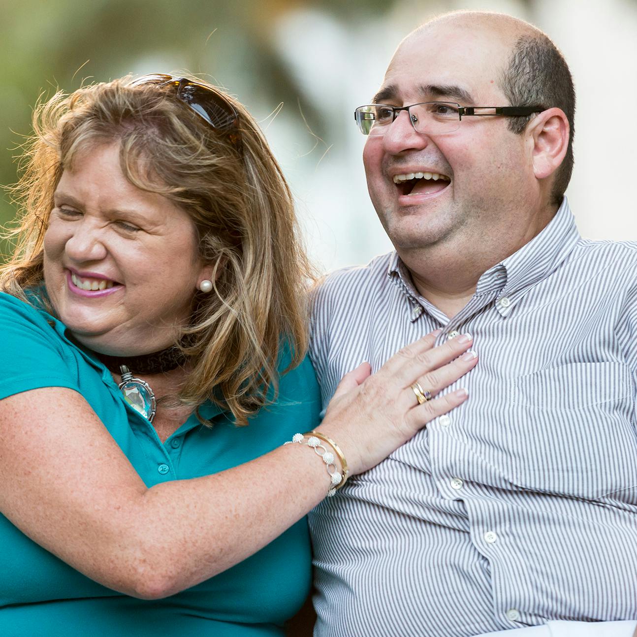 Older couple sitting next to each other laughing