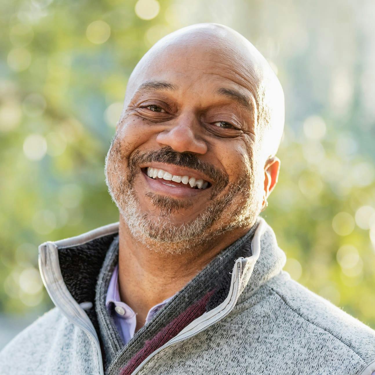Older man smiling outside
