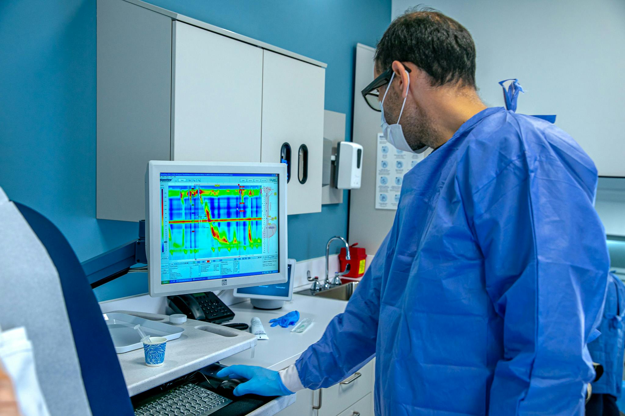 Doctor looking at data on a computer screen