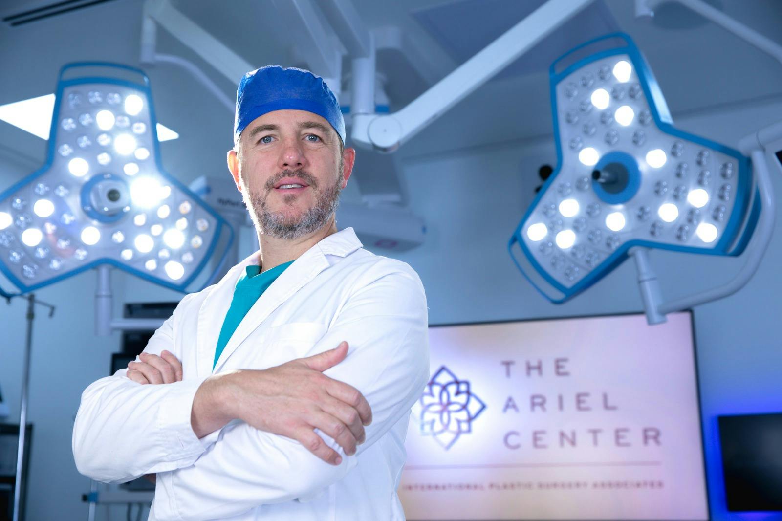 Dr. Juan Cuellar in front of The Ariel Center sign