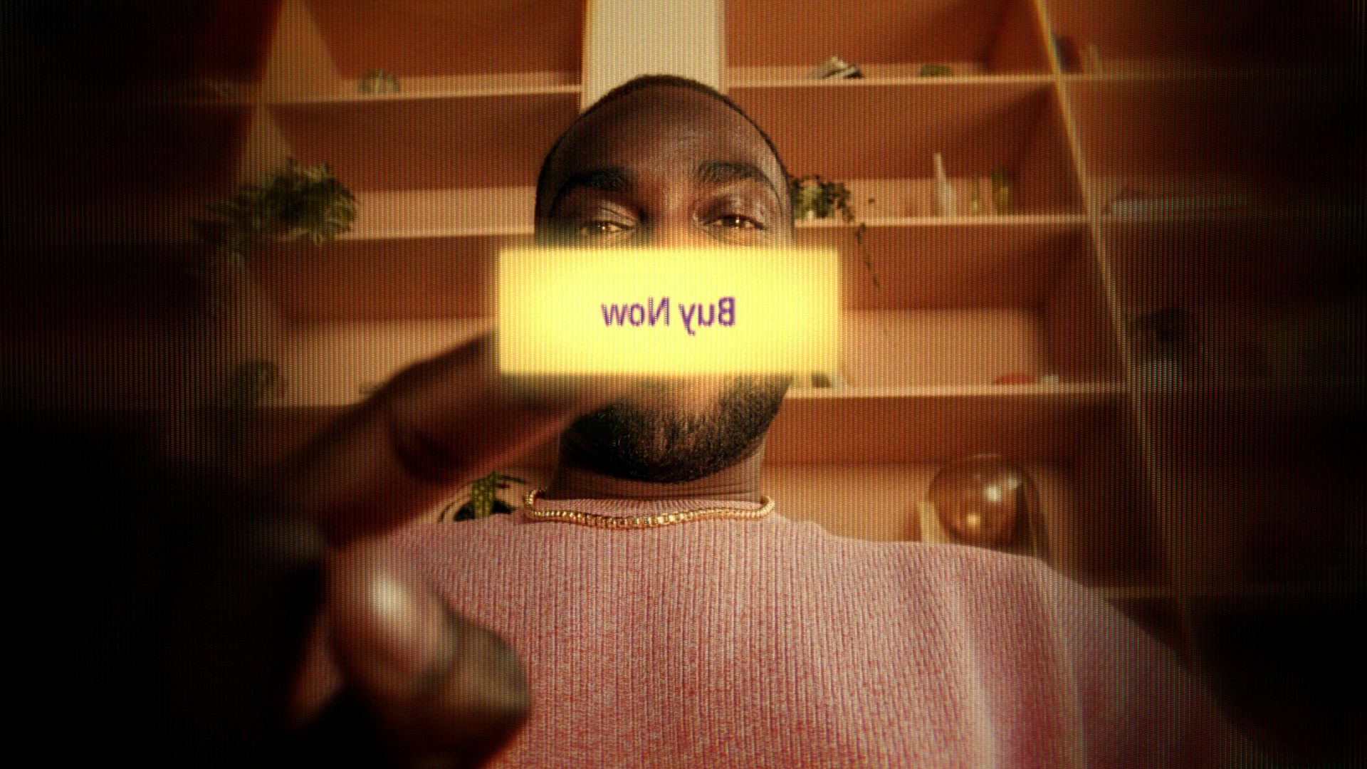 Man infront of a shelve pushing a giant 'buy now' button on his phone screen