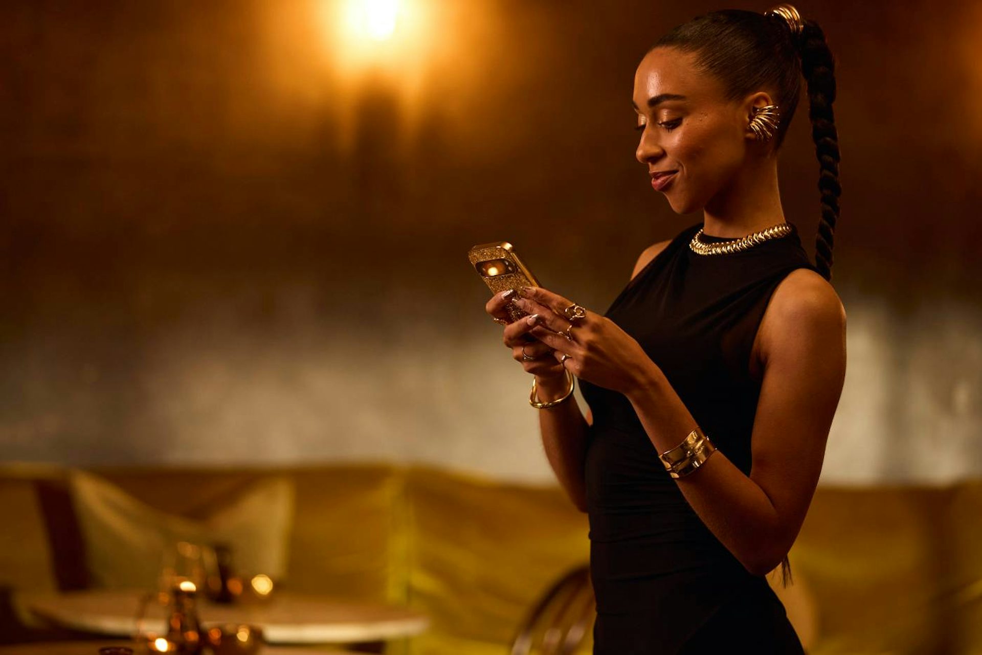 Lady staring into her phone in a golden case