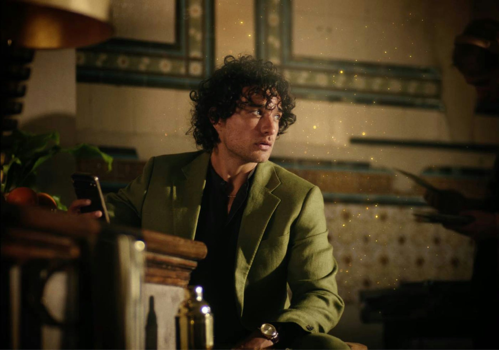 A young man in green coat