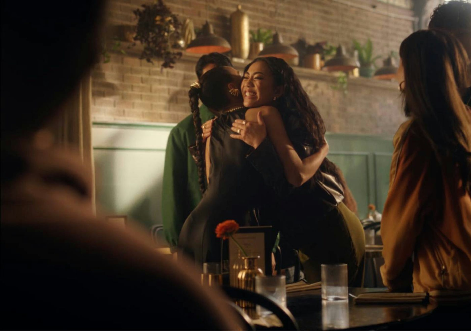 Two ladies hugging in a social scene
