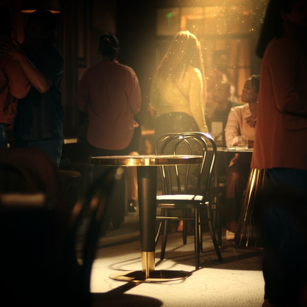A social scene with light shining on a round table