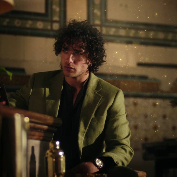 A young man in green coat