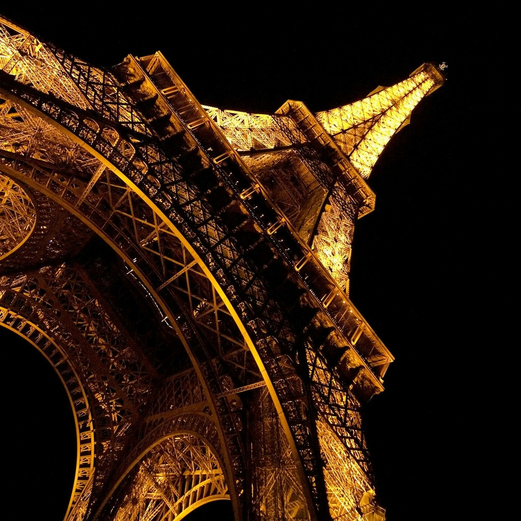 Eiffel Tower at night with lights on.