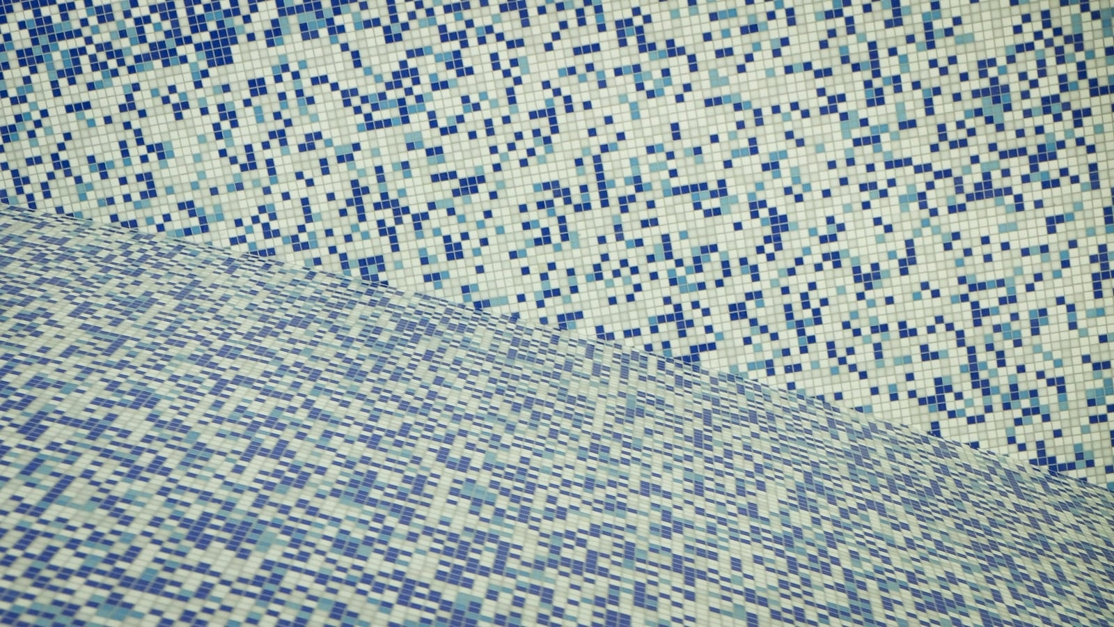 A blue and white mosaic tile pattern on the wall.