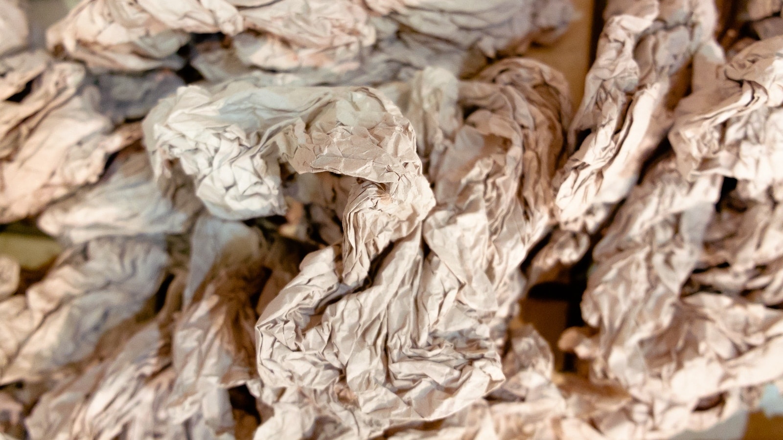Scrunched-up newspaper or paper bags piled up.