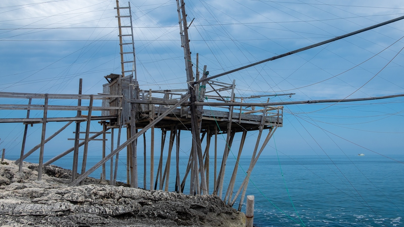 Fishing platform on the shoreline with a serene ocean backdrop