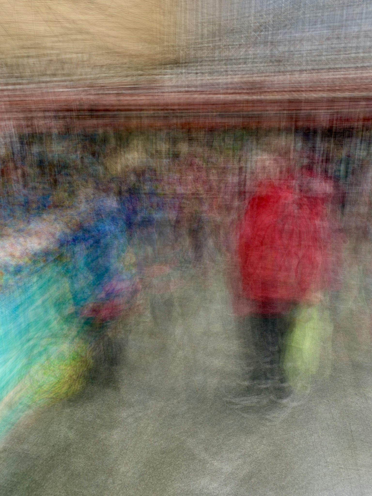 The image shows a blurred scene of a bustling market with various colorful stalls and people milling about, highlighting a person in a red coat.