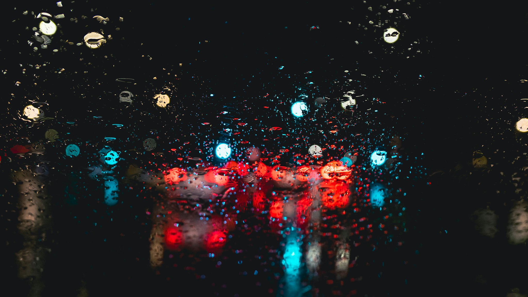 Car lights shining through raindrops