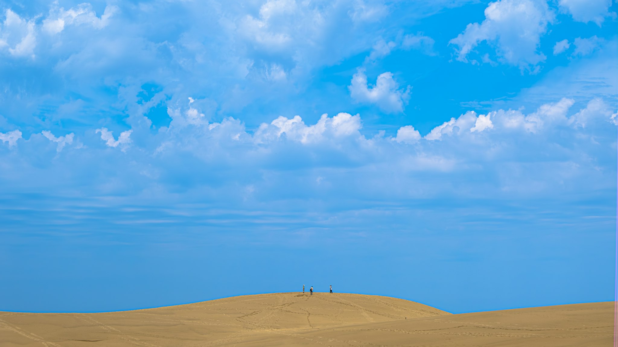 Beach scene with blue sky and sand dunes