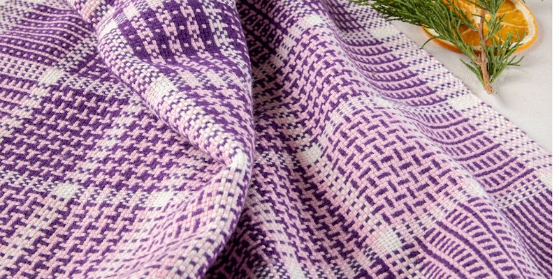 Tammy Bast’s Sugar Plum Towels are a great way to explore color-and-weave patterns on your rigid-heddle loom. Photo credit: Matt Graves