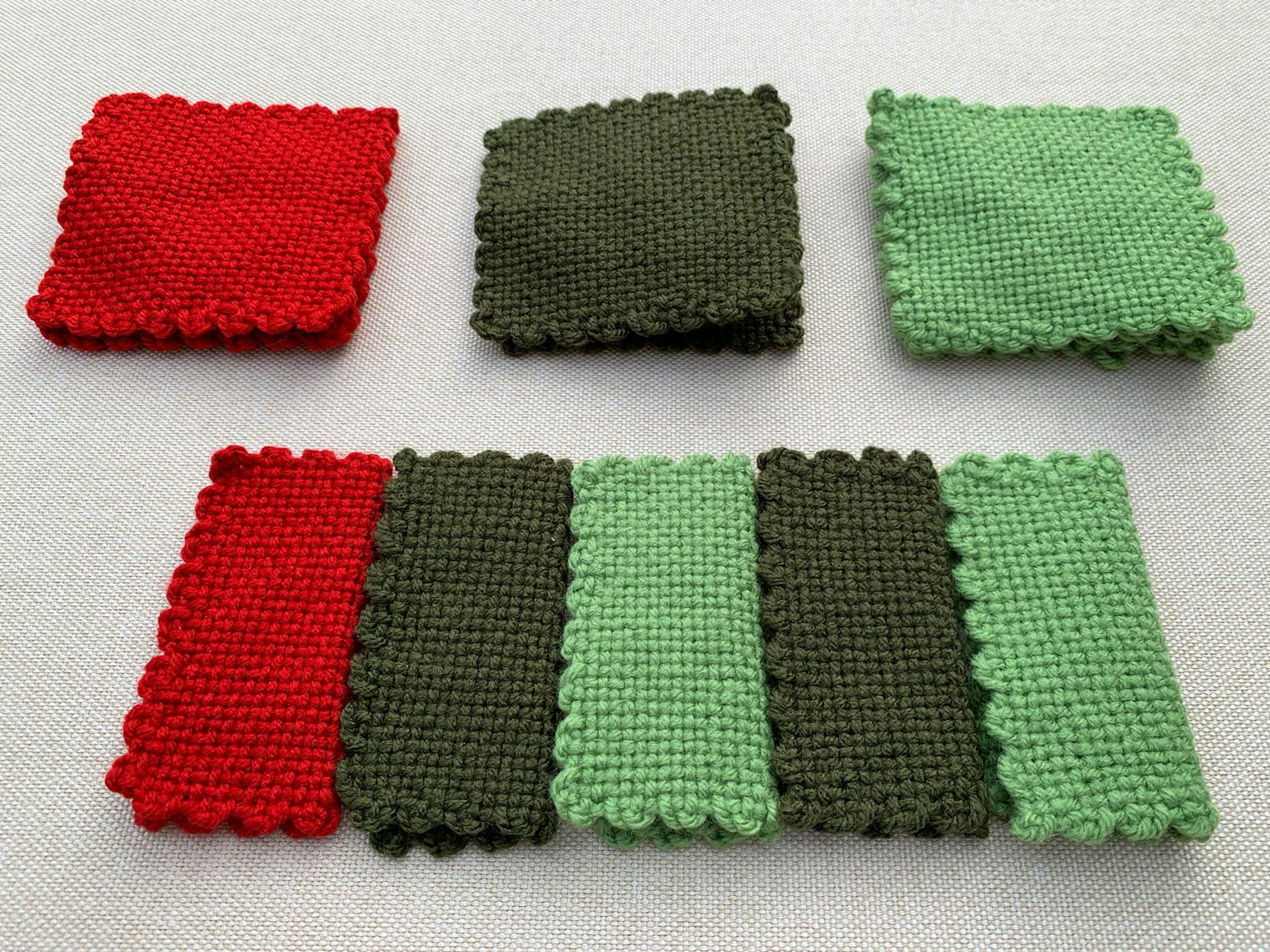 In this example you can see the original pin loom squares above, and their folded counterparts below, ready to sew together. Photo by Tiffany Warble