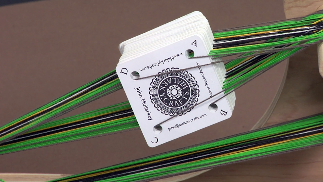 A close up of weaving tablets (cards) as shown in the video course Tablet Weaving Made Easy with John Mullarkey.