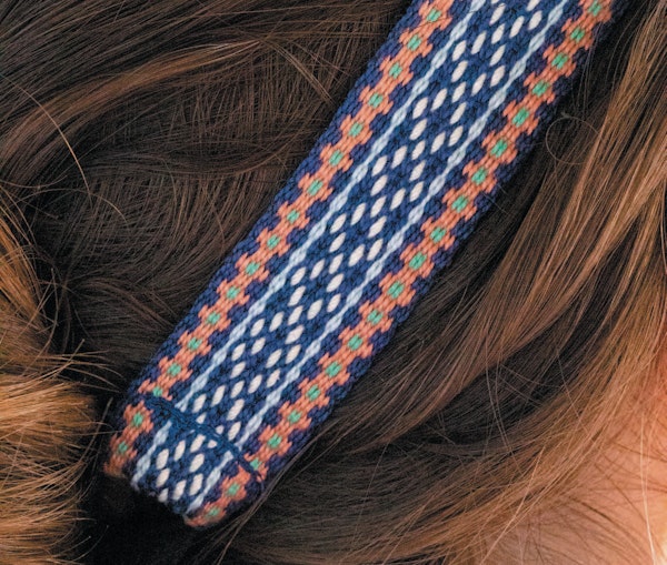 A close-up view of the floral borders featured on the Portland Spring Inkle-Woven Headband and Bracelet by Laia Robichaux