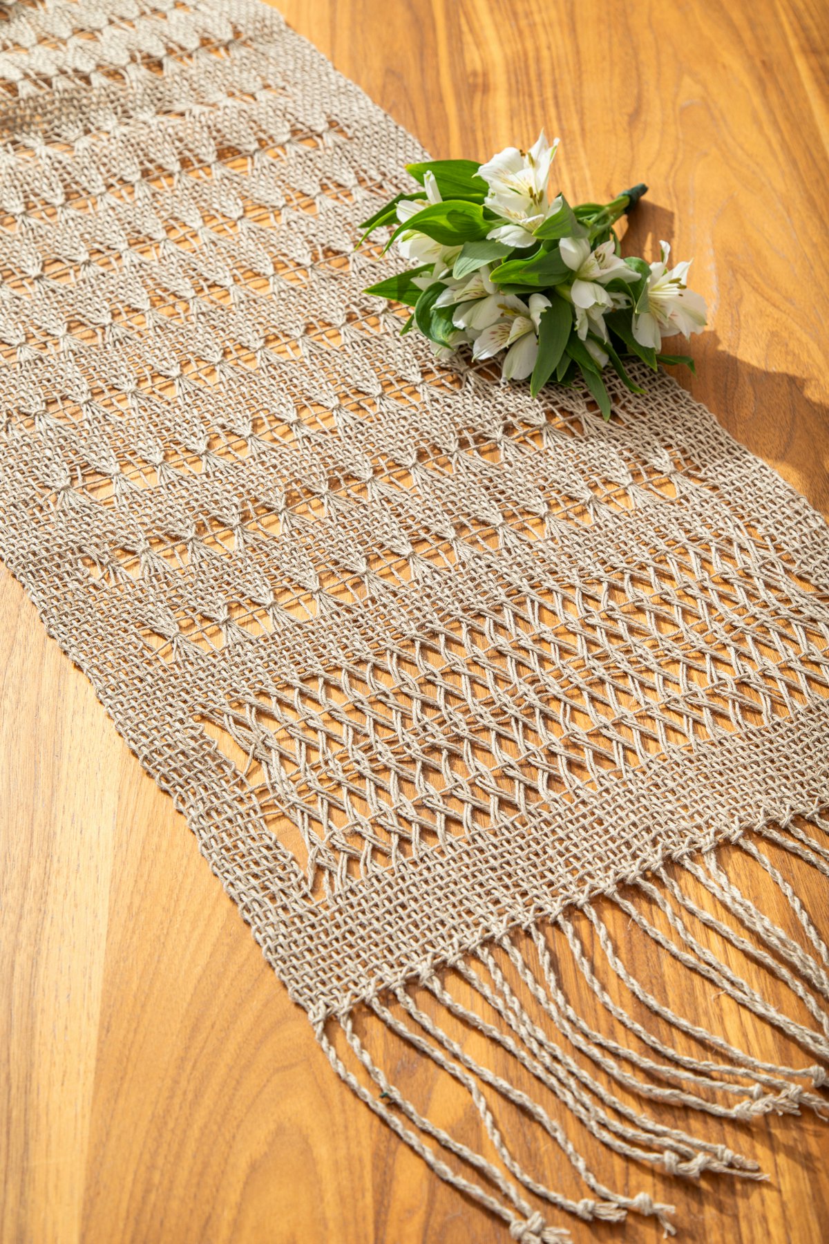 Sheleigh Peers combined sturdy hemp and delicate lace to create her simply stunning Sheaves of Wheat Table Runner. While the Brooks bouquet and leno lace may look fragile, the bast fiber makes for a cloth that can be used and loved for generations.