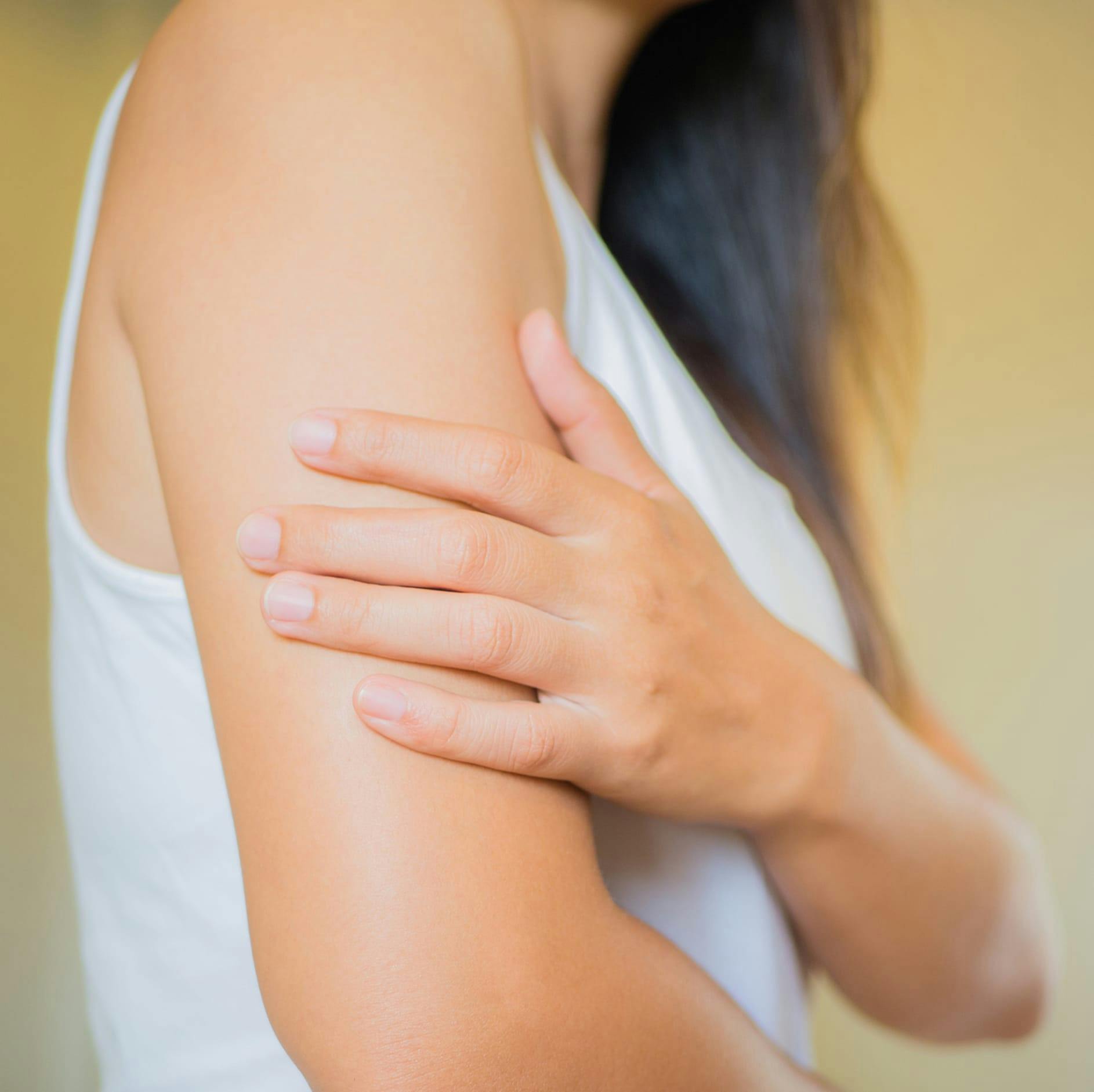 woman with her hand on her arm